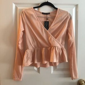 Pink wrap front peplum top